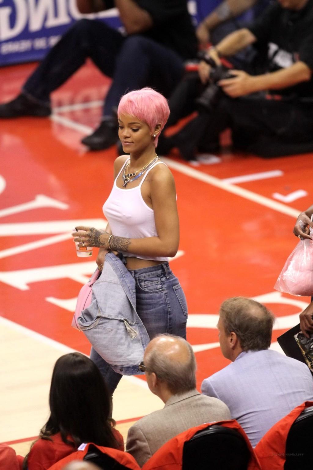 16P Rihanna braless wearing a white top at the Clippers game in LA