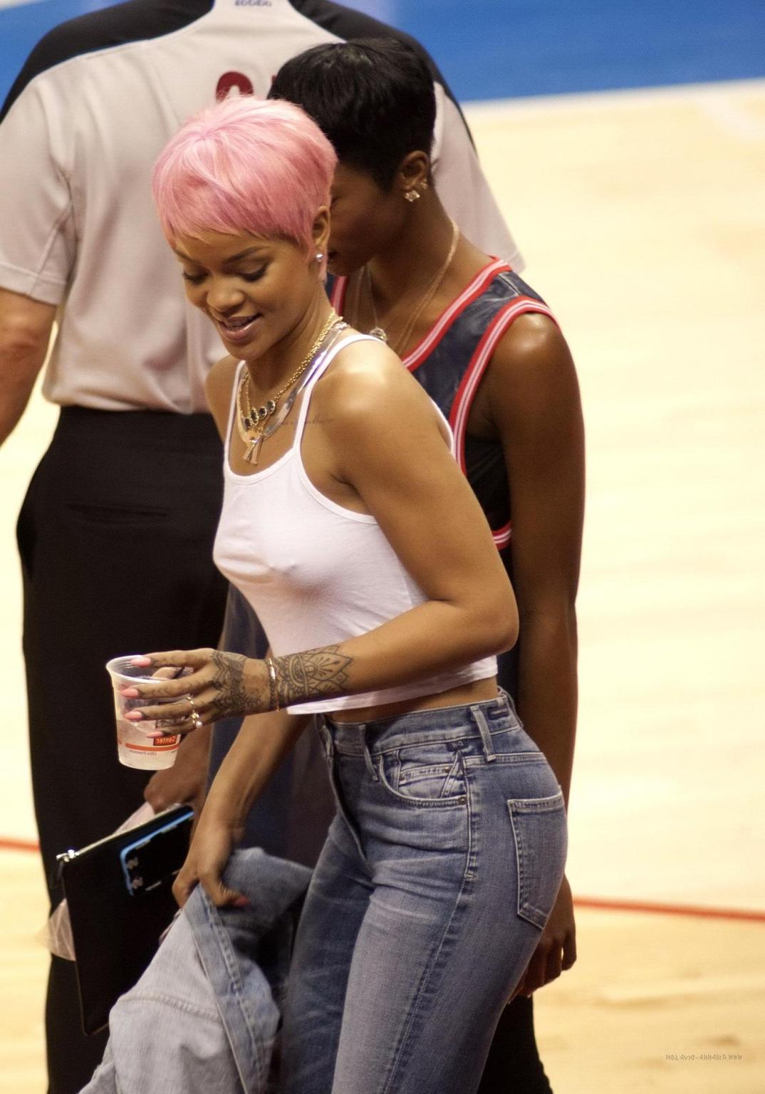 16P Rihanna braless wearing a white top at the Clippers game in LA