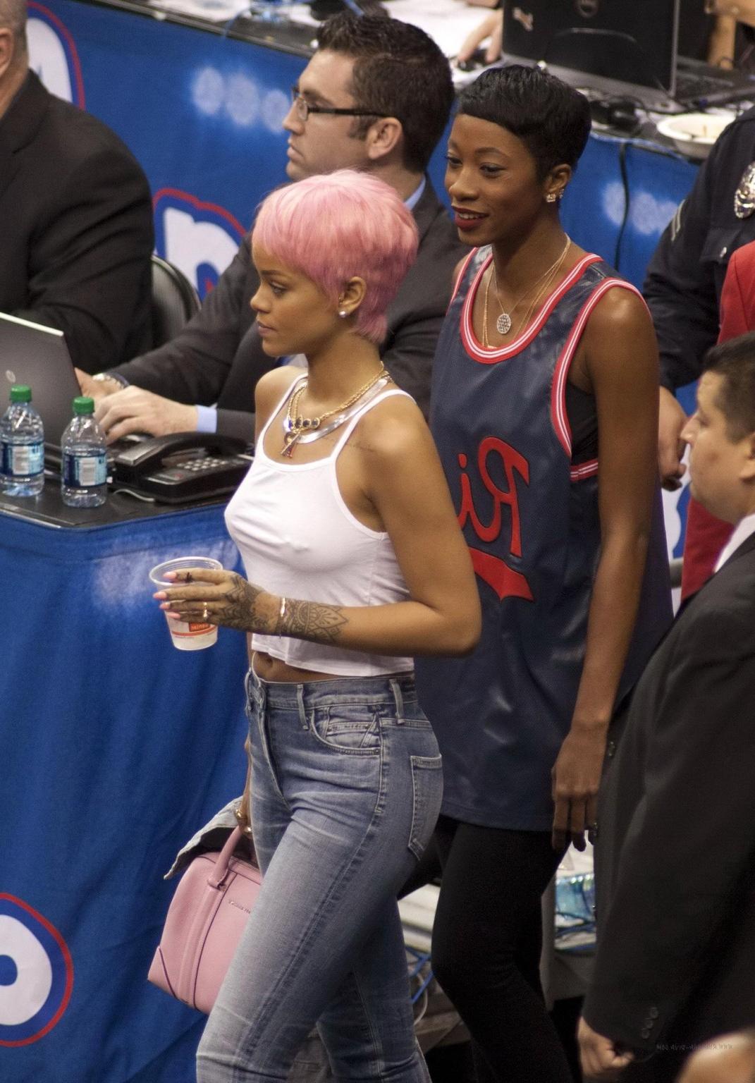 16P Rihanna braless wearing a white top at the Clippers game in LA