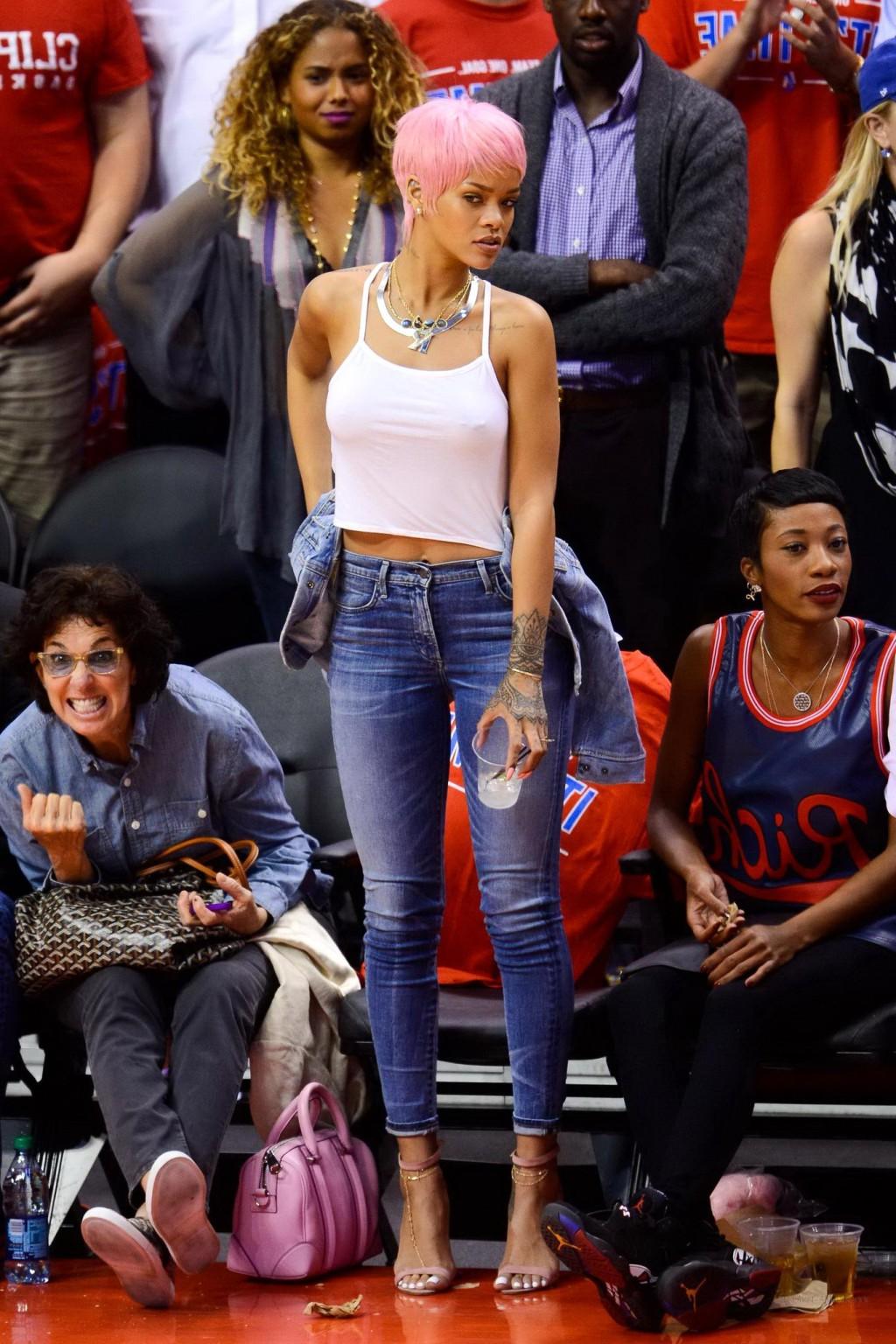 16P Rihanna braless wearing a white top at the Clippers game in LA