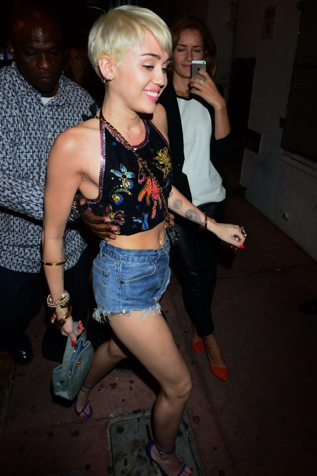 16P Miley Cyrus in denim shorts and belly top at Cameo Nightclub in Miami