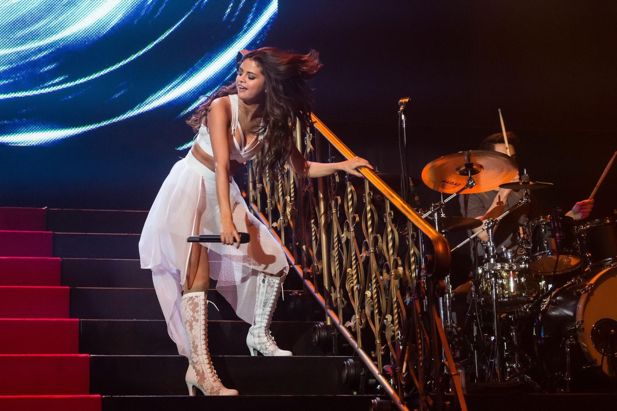 16P Selena Gomez wearing tiny white belly top and see-through skirt while performs a