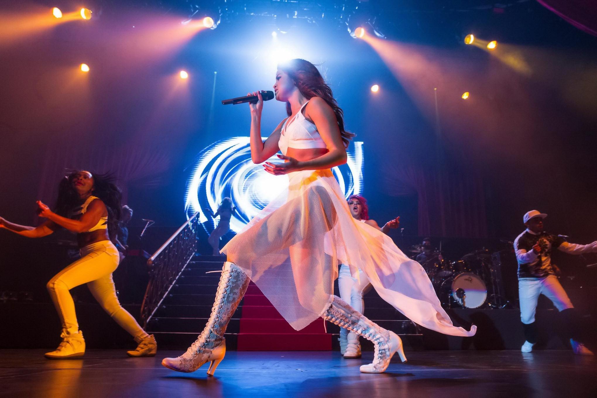 16P Selena Gomez wearing tiny white belly top and see-through skirt while performs a