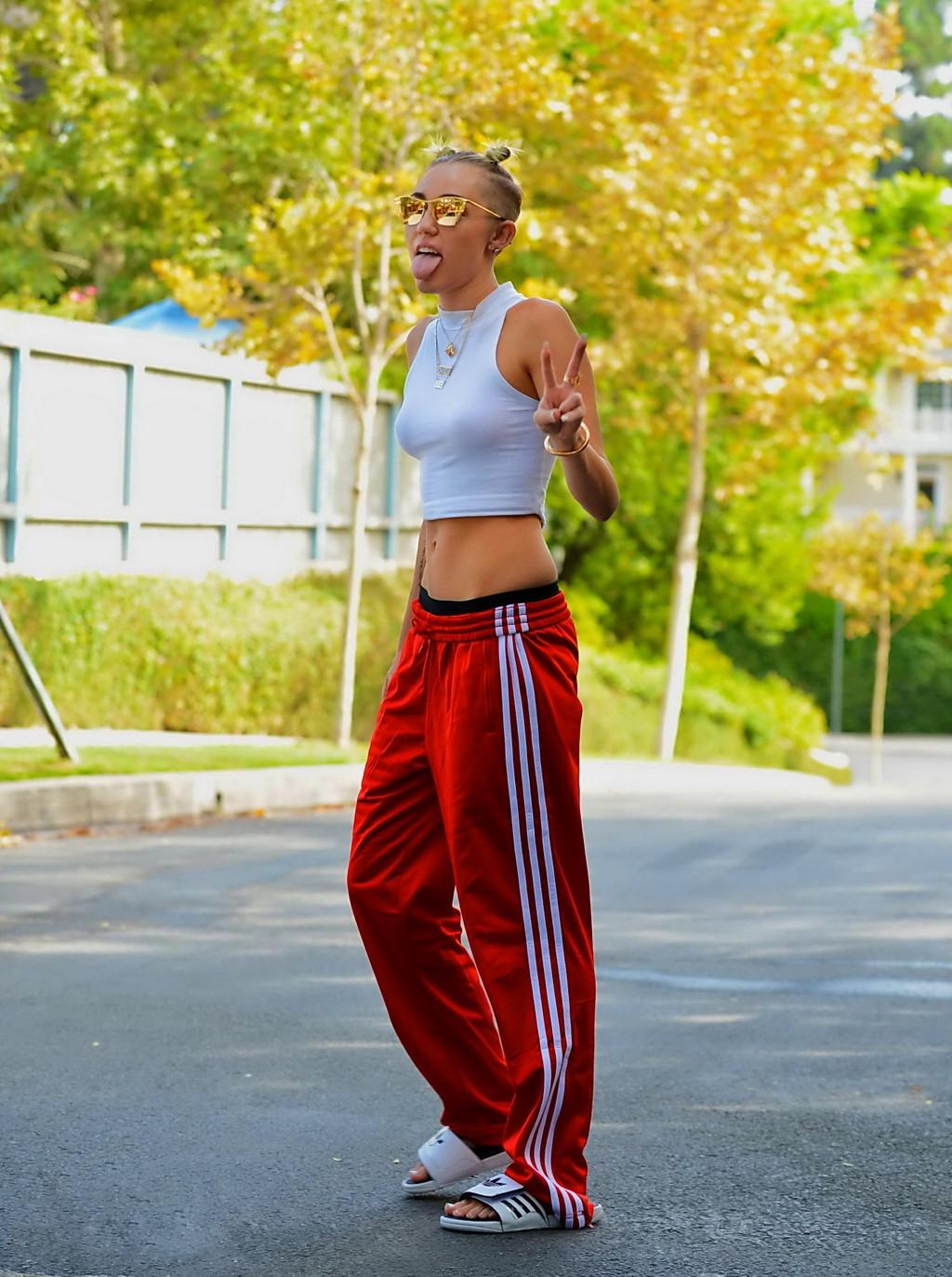 16P Miley Cyrus wearing white see-through belly top and red suits bottom out in Los 