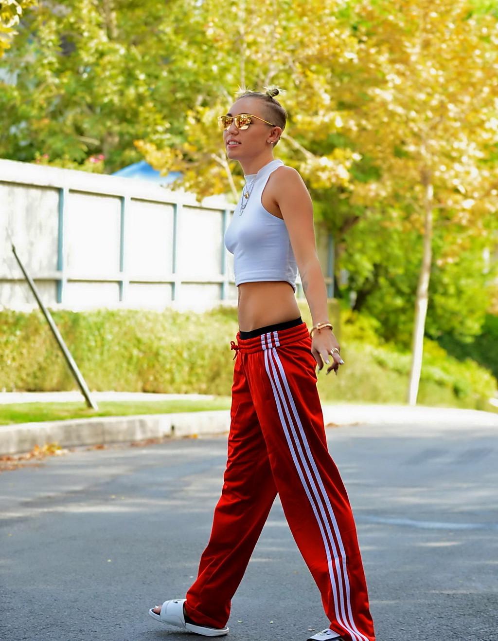 16P Miley Cyrus wearing white see-through belly top and red suits bottom out in Los 