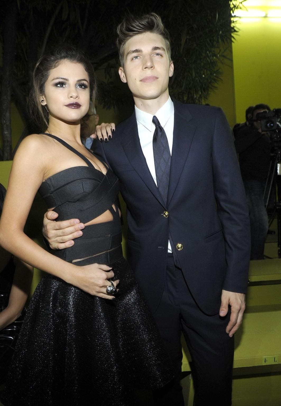 16P Selena Gomez cleavy wearing a sexy black dress at Versace fashion show in Milan