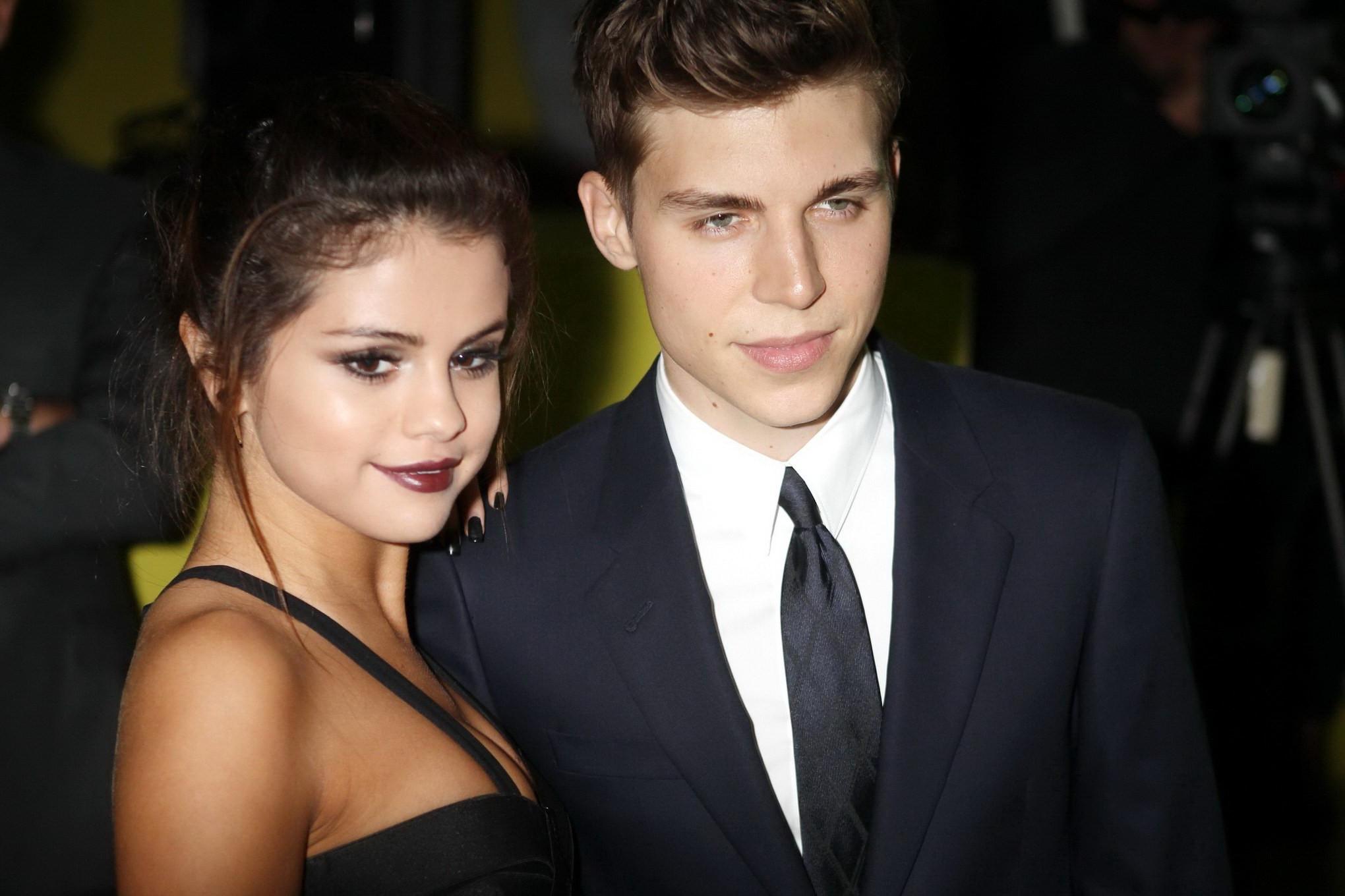 16P Selena Gomez cleavy wearing a sexy black dress at Versace fashion show in Milan