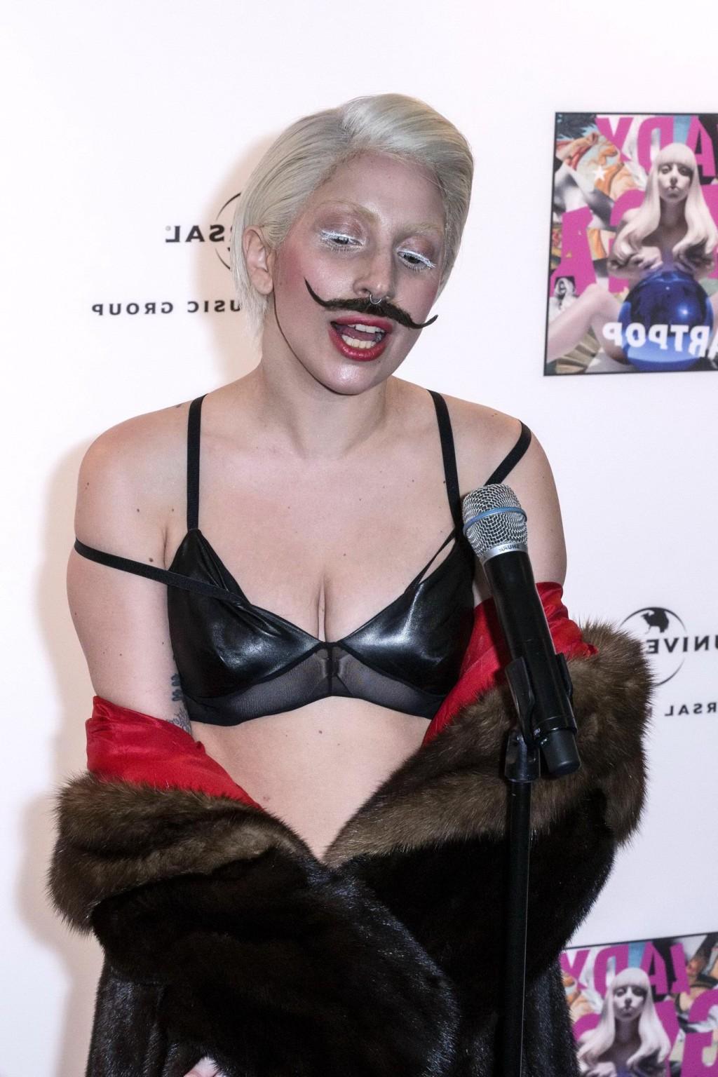 16P Lady Gaga wearing lingerie and fake moustache at her album promotion in Berlin