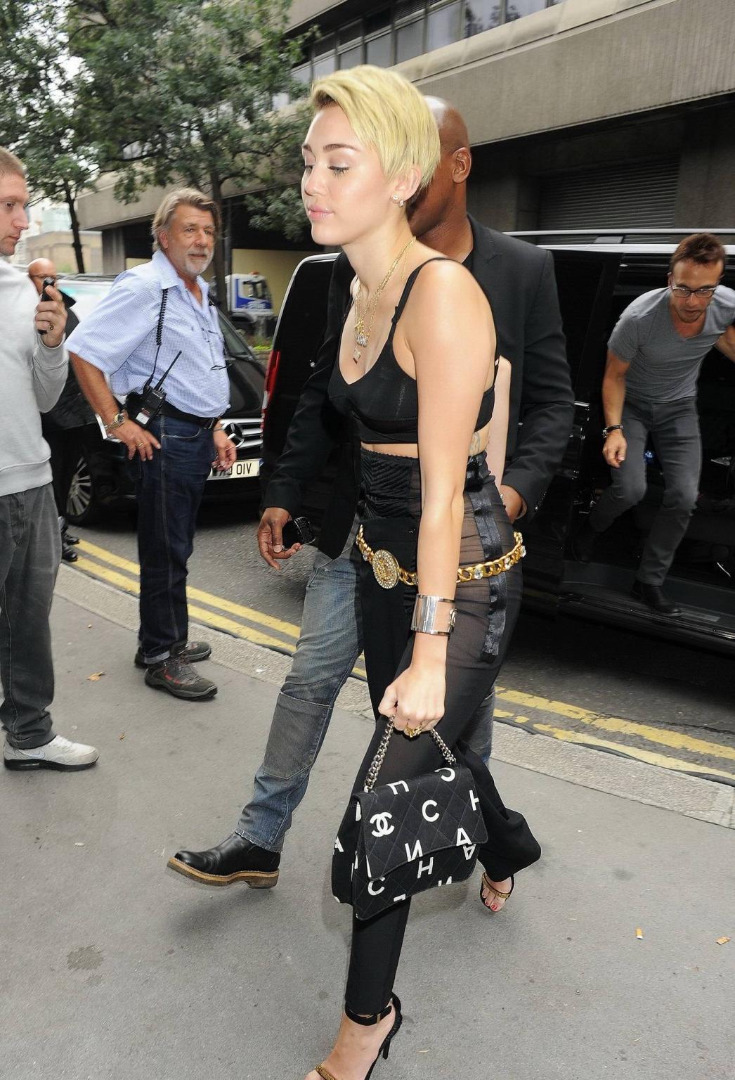16P Miley Cyrus pantyless wearing black see-through pants and belly top outside her 