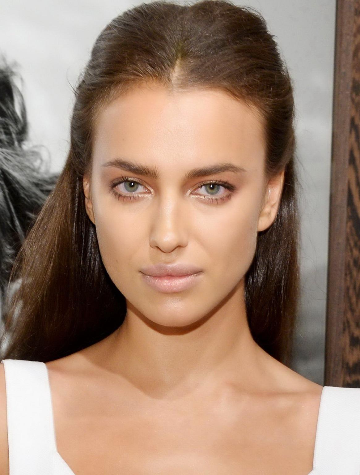 9P Irina Shayk wearing tiny white belly top and black pants at the Peter Lindbergh 
