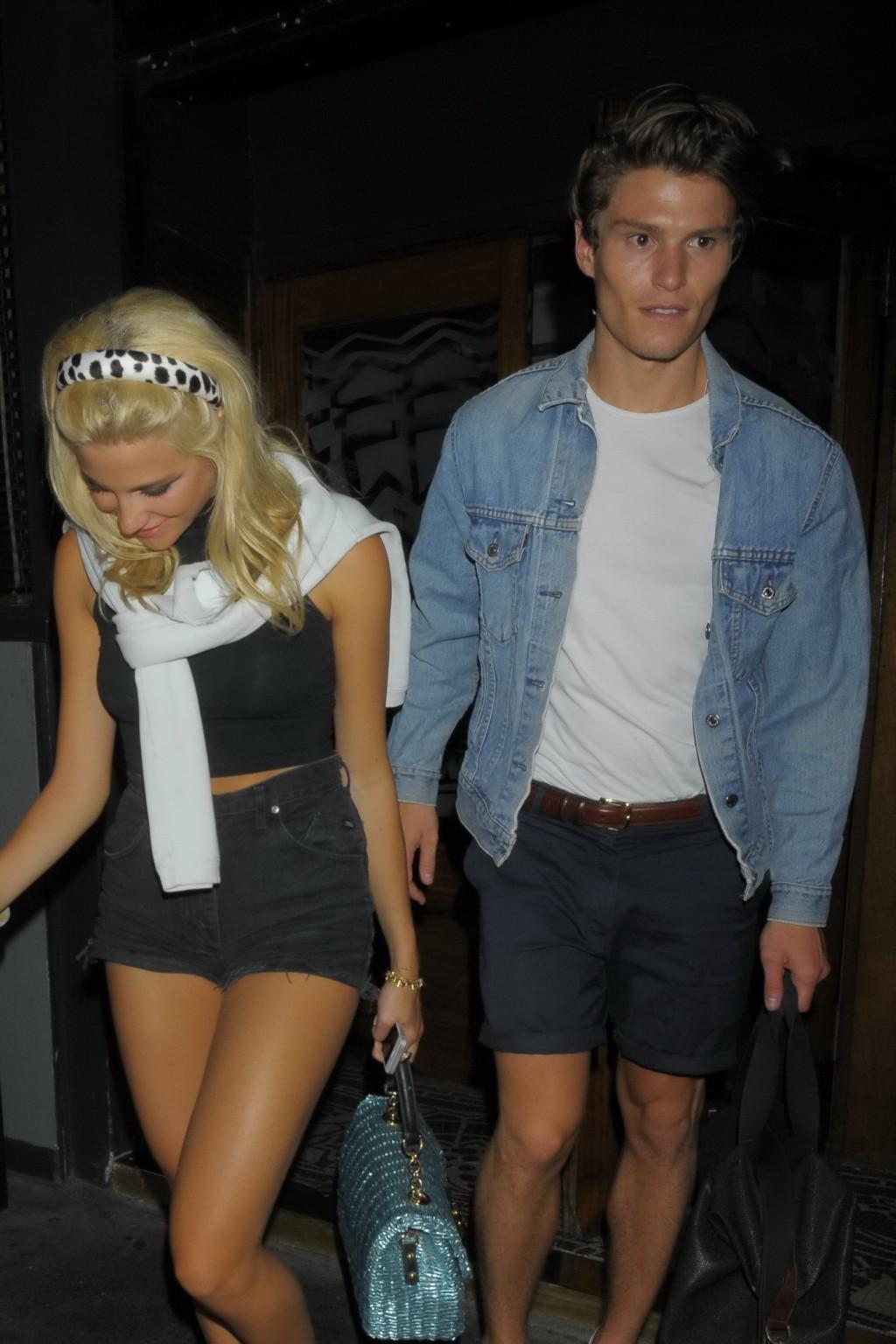 16P Pixie Lott wearing tight black belly top and shorts night out in London