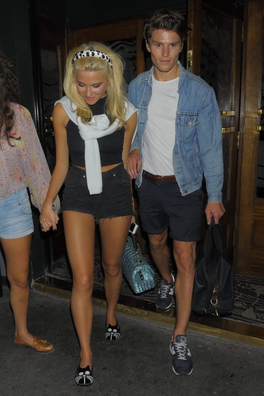 16P Pixie Lott wearing tight black belly top and shorts night out in London