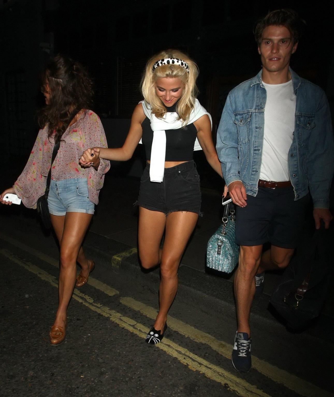16P Pixie Lott wearing tight black belly top and shorts night out in London