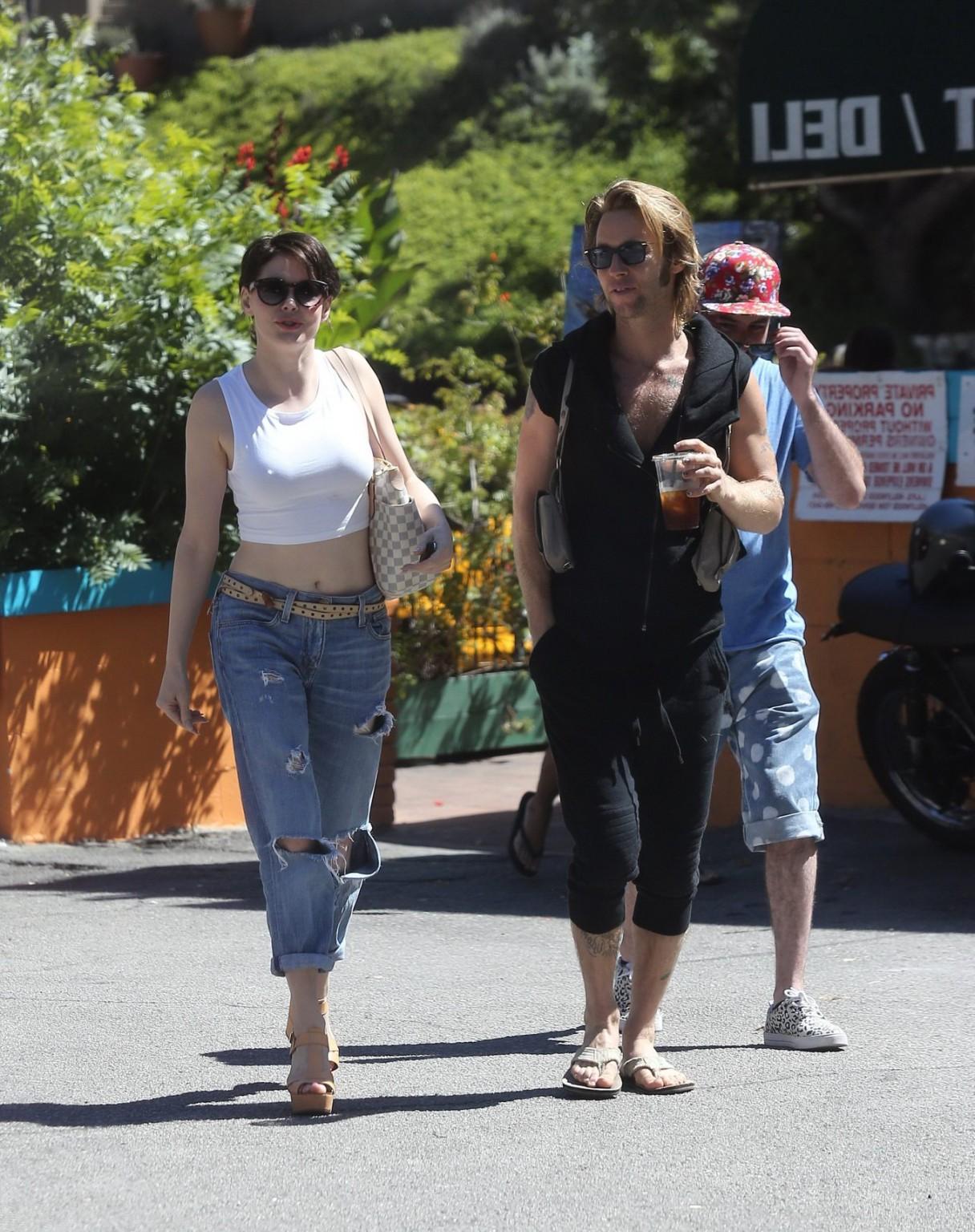 16P Rose McGowan flaunting her huge assets braless in white belly top and ripped jea