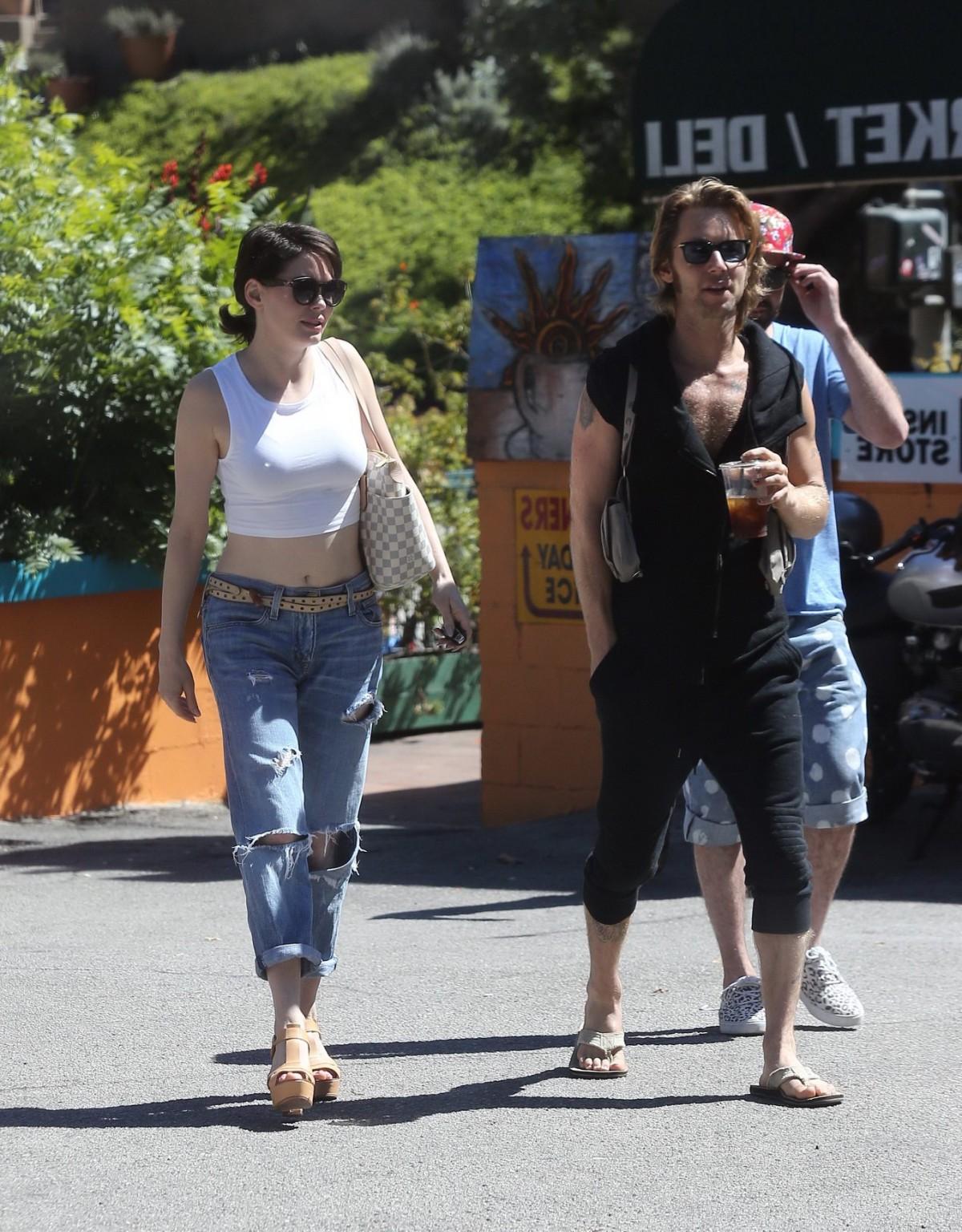 16P Rose McGowan flaunting her huge assets braless in white belly top and ripped jea