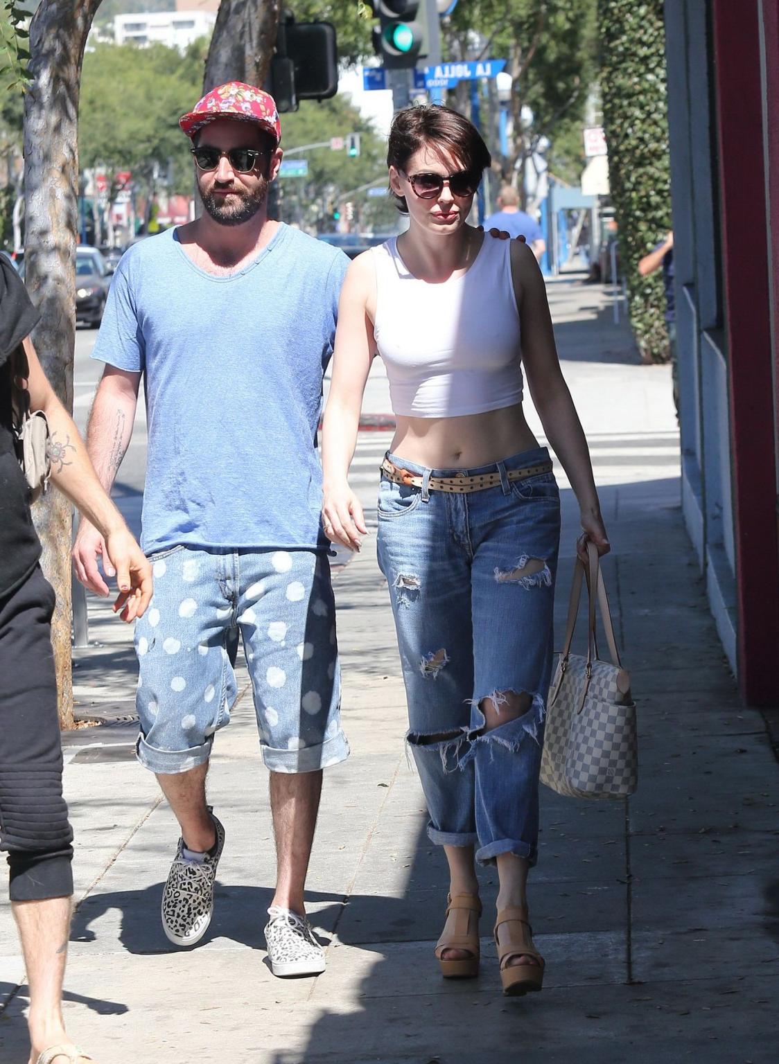 16P Rose McGowan flaunting her huge assets braless in white belly top and ripped jea