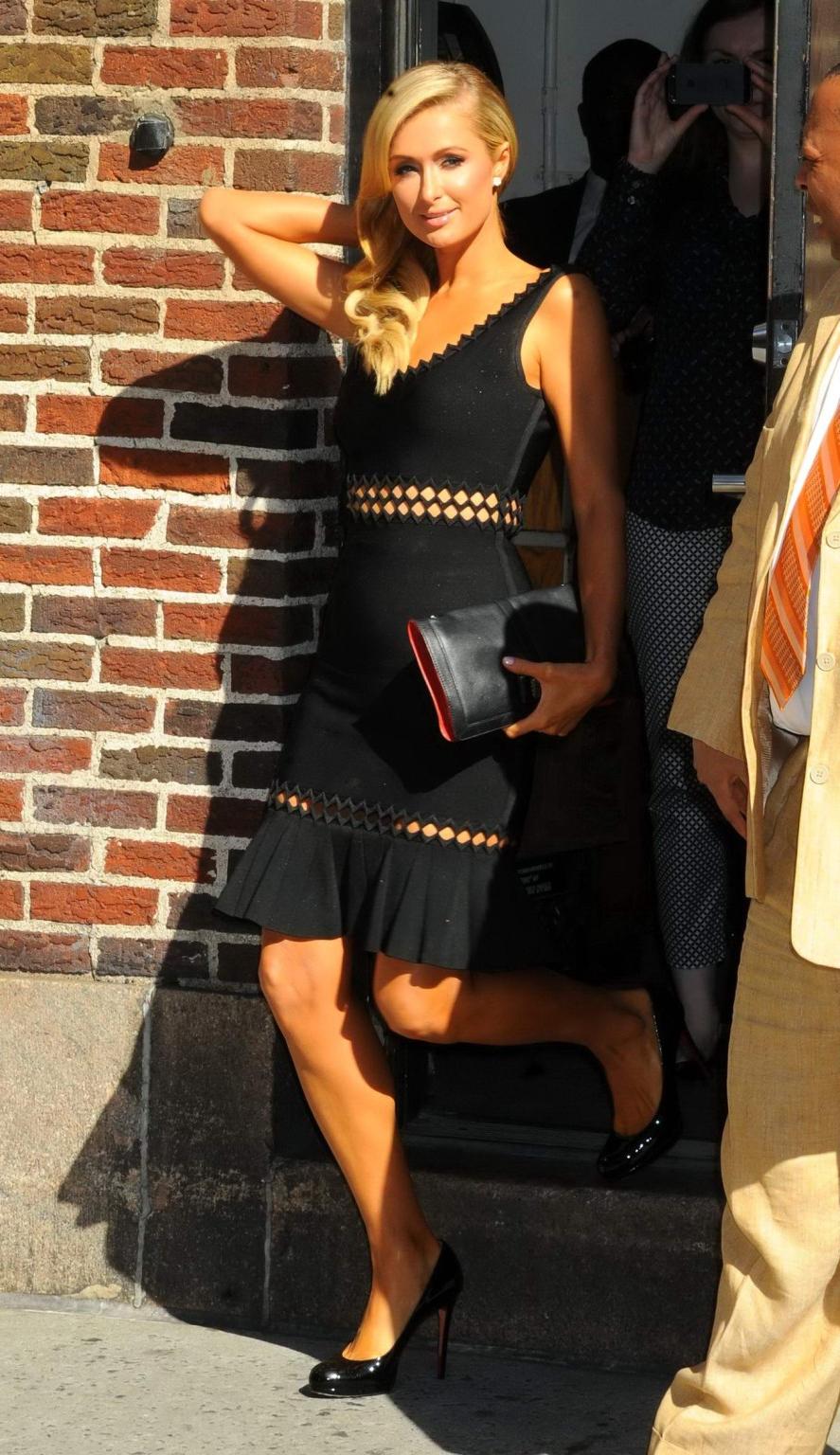 16P Paris Hilton shows pokies wearing a tight black dress at the Late Show with Davi