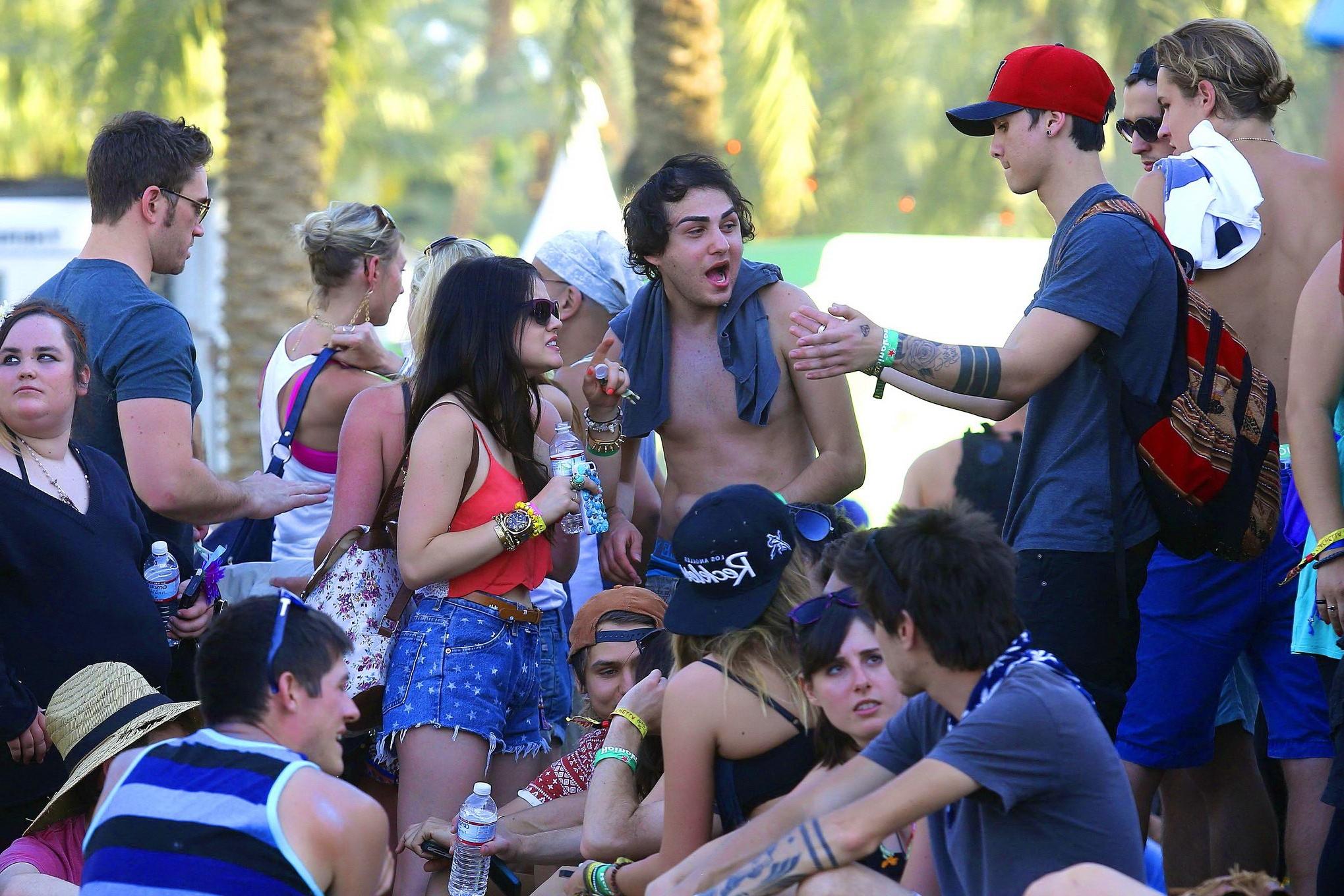 16P Lucy Hale wearing tiny red belly top and denim shorts at 2013 Coachella Music an