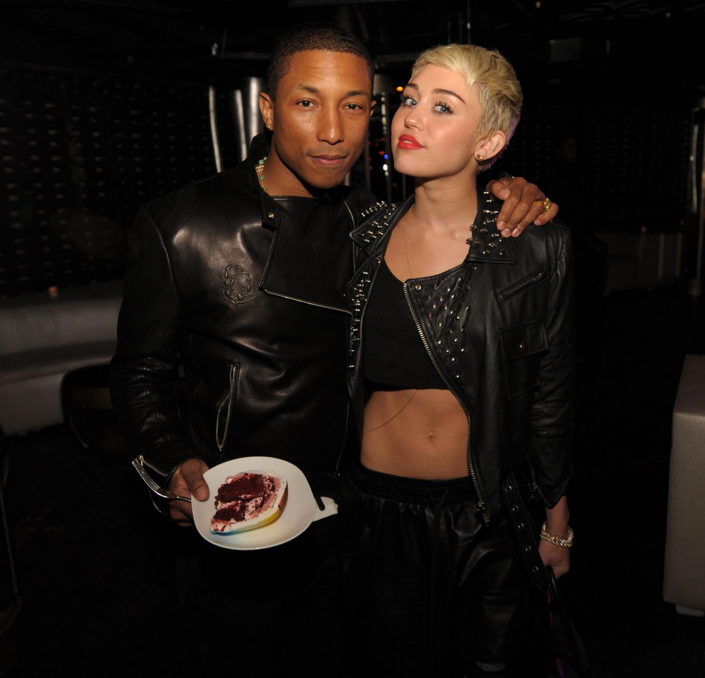 16P Miley Cyrus wears black belly top and leather shorts at Pharrell Williams's birt