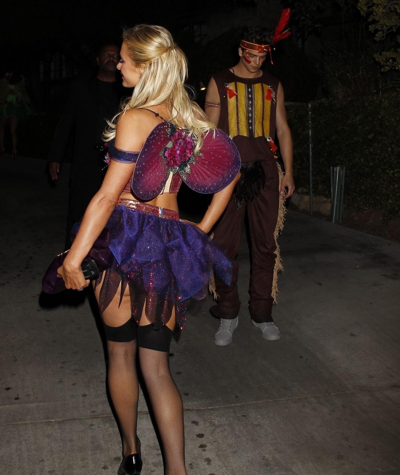 10P Paris Hilton wearing a belly top  stockings at the Halloween party in LA