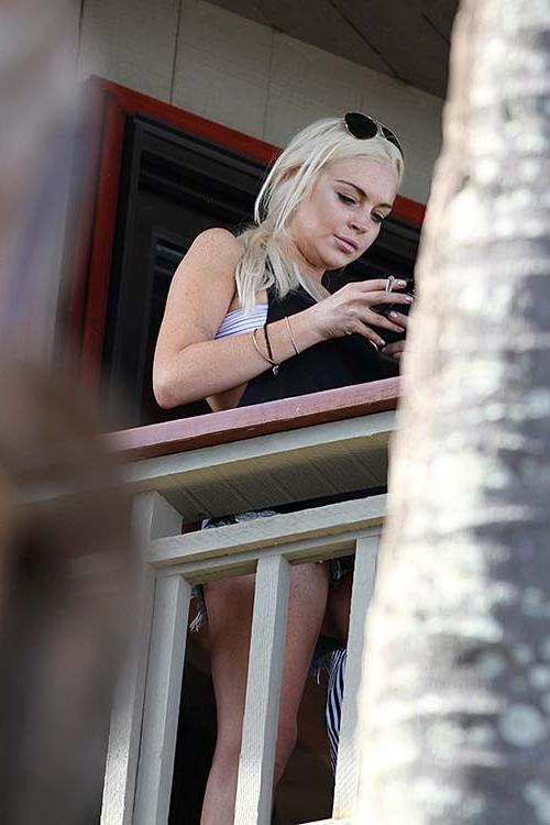 16P Lindsay Lohan spreading her sexy legs at the balconcy of hotel