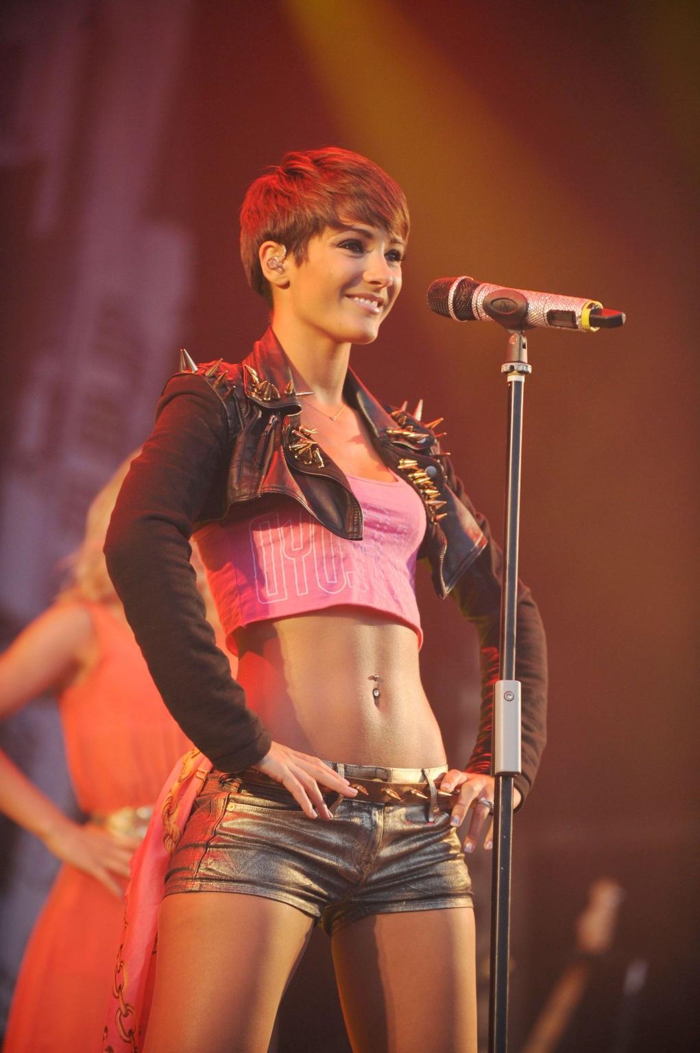 16P Frankie Sandford performs wearing shorts  belly top at the English Heritage Picn