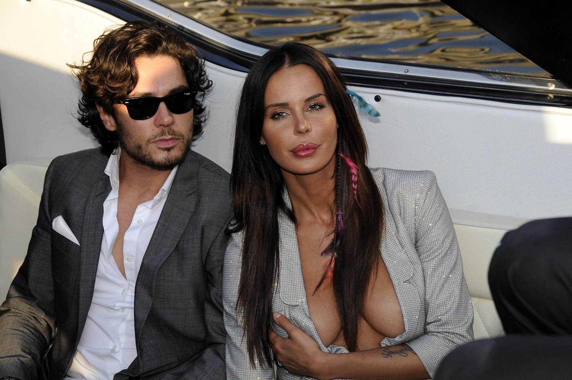 10P Nina Moric exposing her bare pussy upskirt in car paparazzi pictures and showing