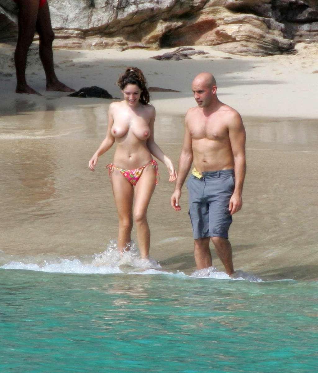 10P Kelly Brook showing big cleavage and upskirt in car and topless on beach