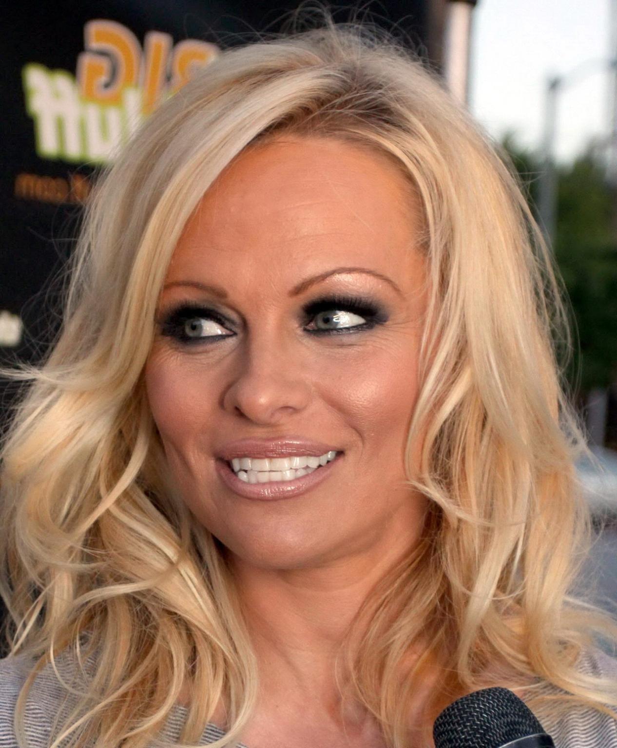 16P Pamela Anderson leggy in mini dress at 'The Big Bluff' online game launch