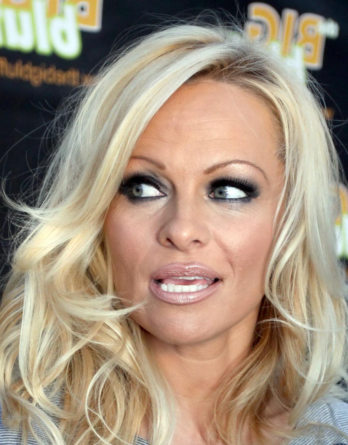 16P Pamela Anderson leggy in mini dress at 'The Big Bluff' online game launch