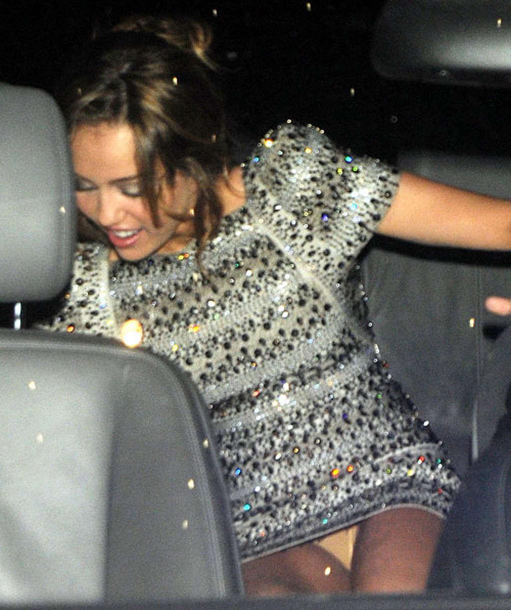 10P Miley Cyrus very leggy in mini skirt and upskirt in car paparazzi pictures