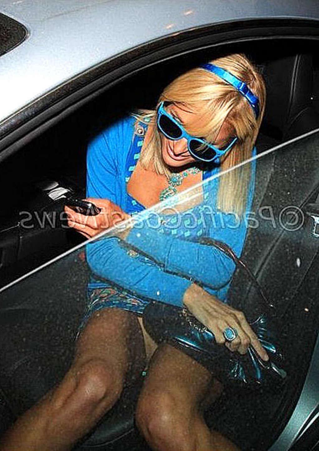 10P Paris Hilton exposing her nice shaved pussy upskirt in car paparazzi pictures an