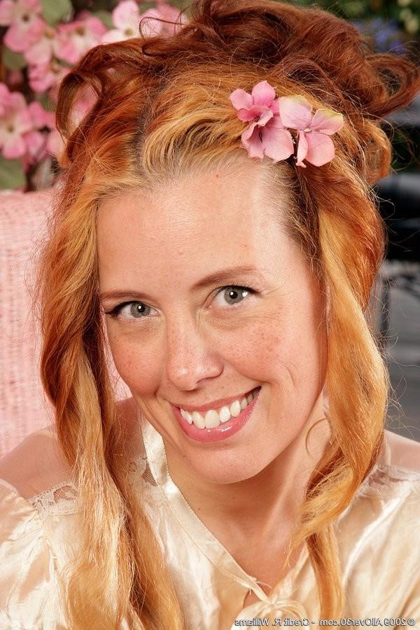 15P Redheaded Housewife In Lace Shows Her Shaved Pussy