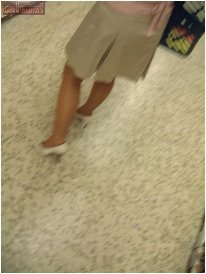 15P Upskirt girl in shop showing here black panties under pantyhose