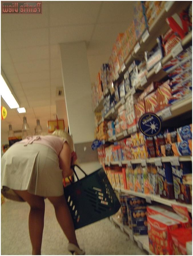 15P Upskirt girl in shop showing here black panties under pantyhose