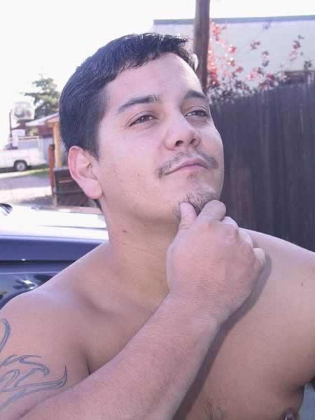 13P Amature guy posing by his red car