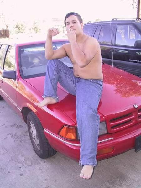 13P Amature guy posing by his red car