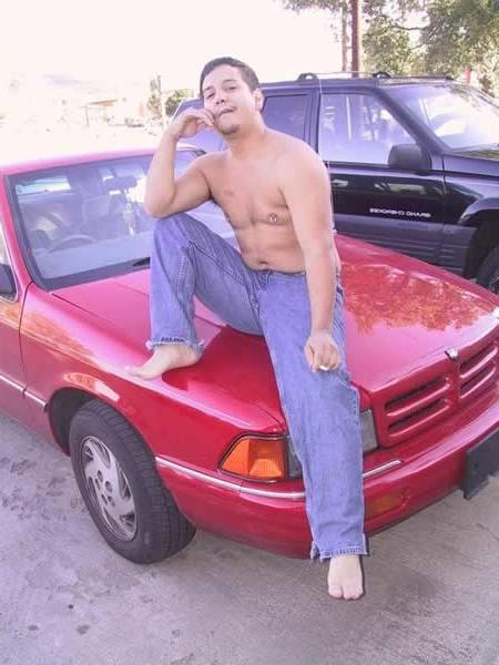 13P Amature guy posing by his red car