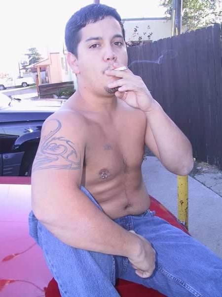13P Amature guy posing by his red car