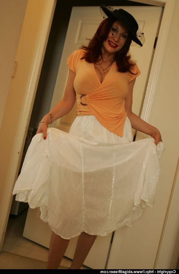 12P Curvaceous mature babe lifting up her skirt and posing with strapon