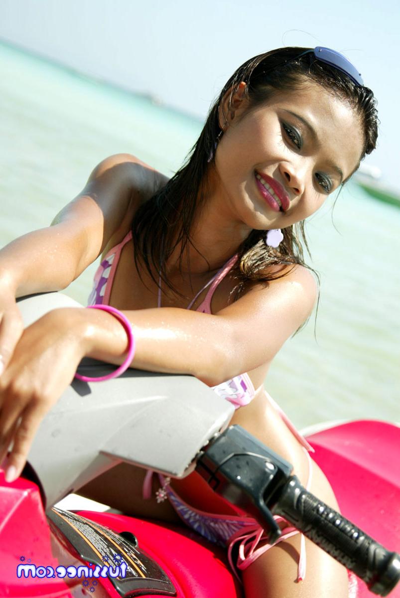 15P Asian teen model at the beach poses on a Jet Ski