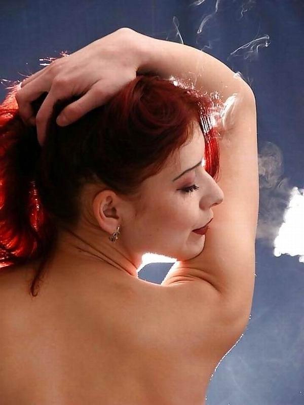 8P Redhead gal smokes a cigarette while she poses