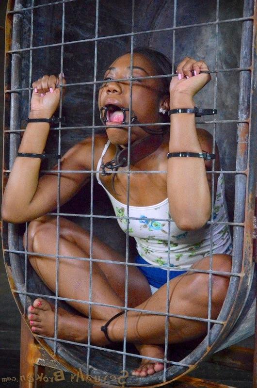 16P Chanell Heart ebony babe is caged and made to suck cock