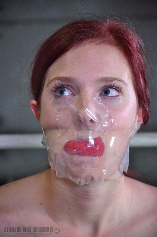16P Ashley Lane redhead is bound with tits exposed and mouth spread
