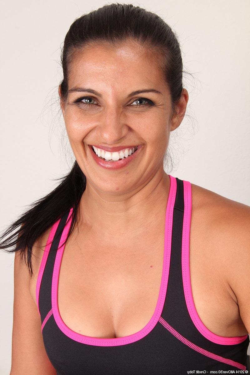 15P Horny mature strips naked after her workout