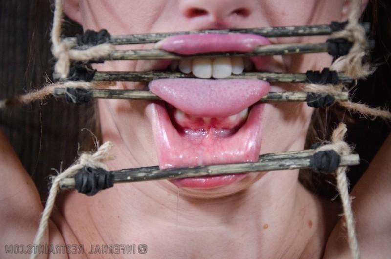 16P Bella Rossi is bound in wood with mouth spreader with clamps on her big tits