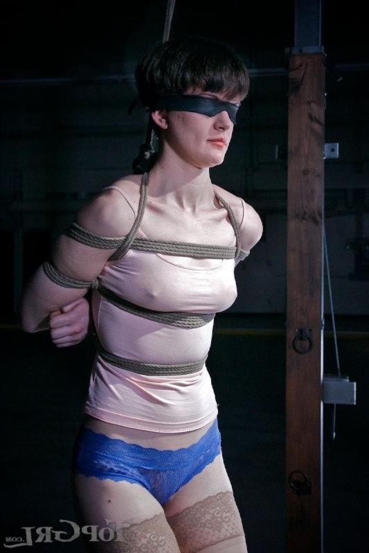 16P Hazel Hypnotic is rope bound wearing high heels in dark dungeon