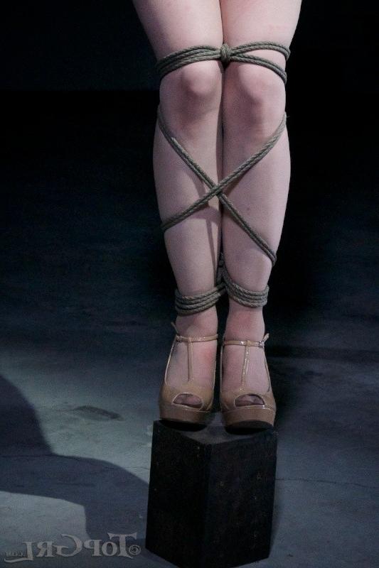 16P Hazel Hypnotic is rope bound wearing high heels in dark dungeon