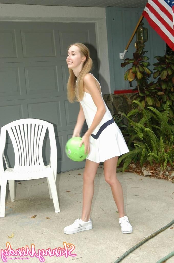 16P Skinny teen girl in pigtails outdoors playing with ball
