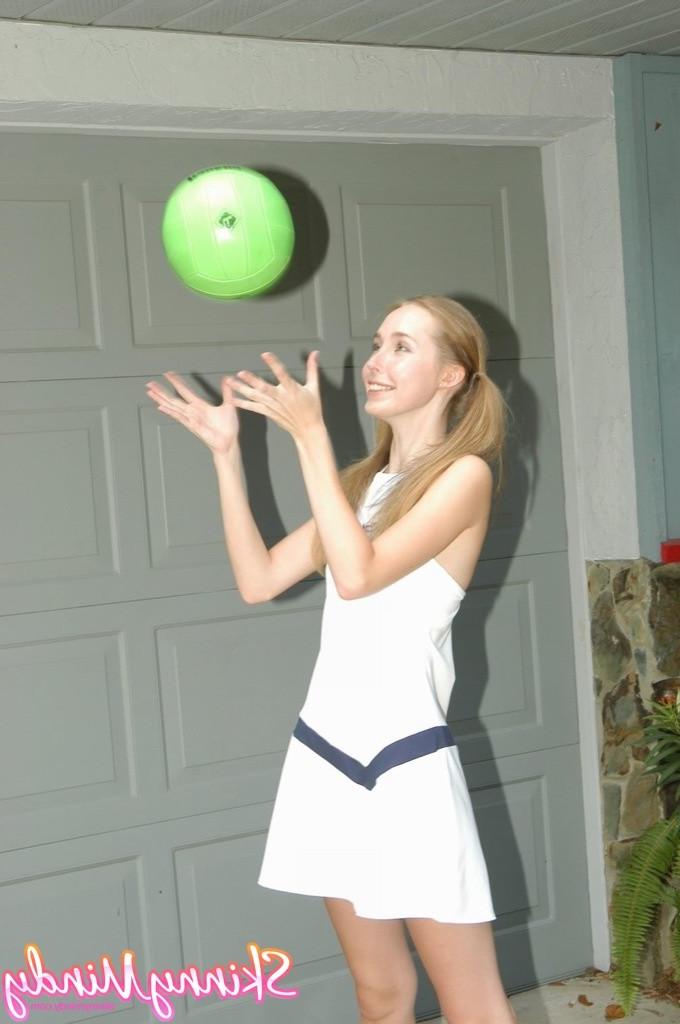 16P Skinny teen girl in pigtails outdoors playing with ball